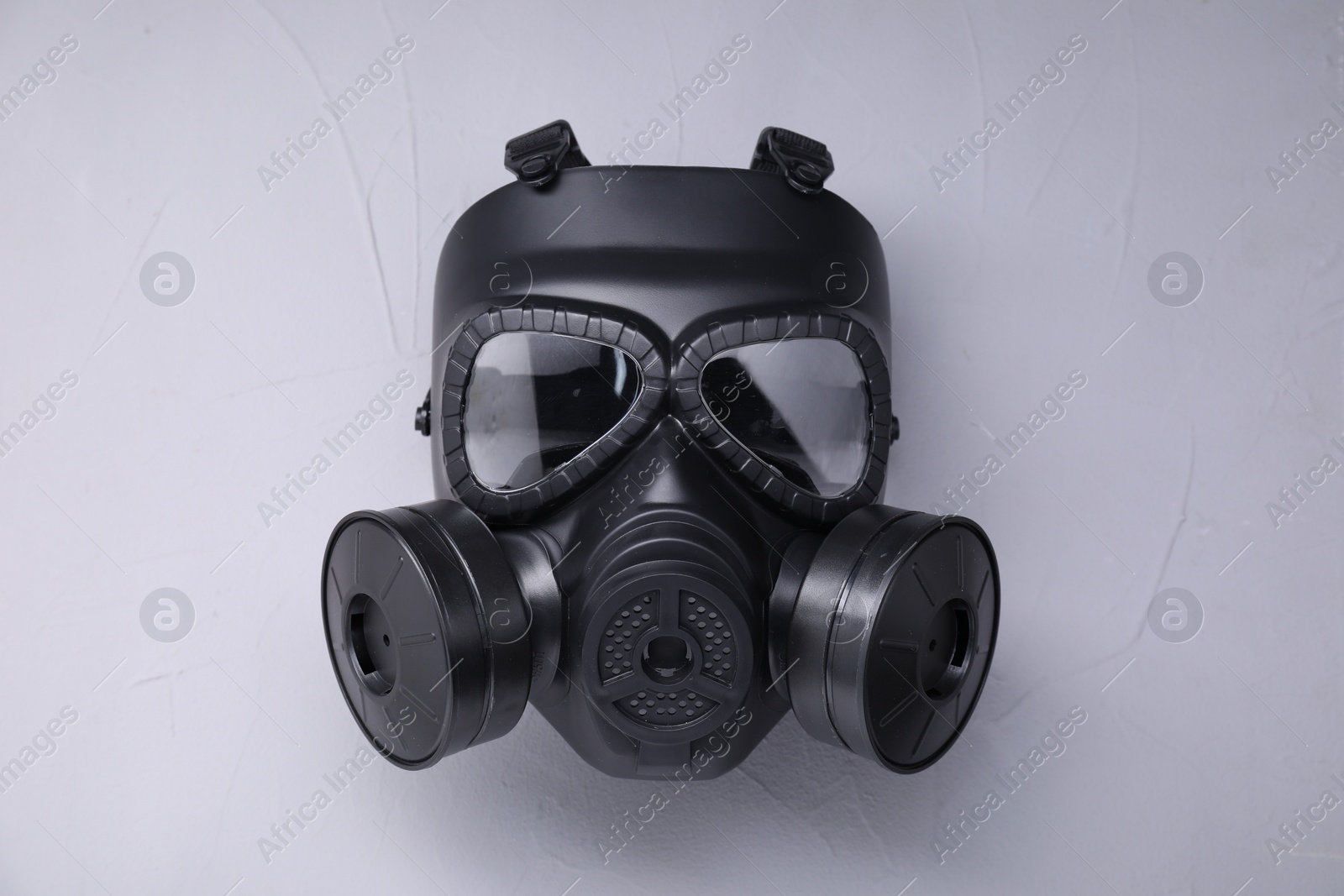 Photo of One gas mask on grey textured background, top view