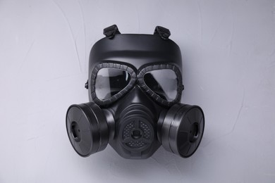 One gas mask on grey textured background, top view