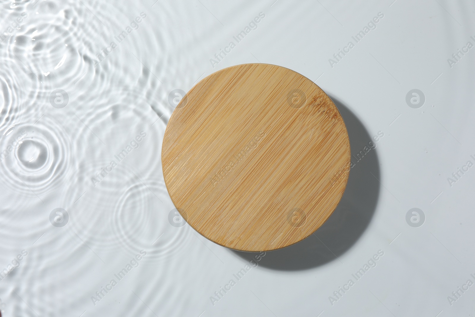 Photo of Presentation for product. Wooden podium in water on white background, top view