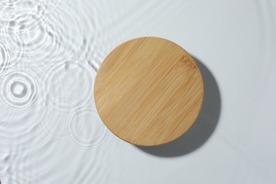 Photo of Presentation for product. Wooden podium in water on white background, top view