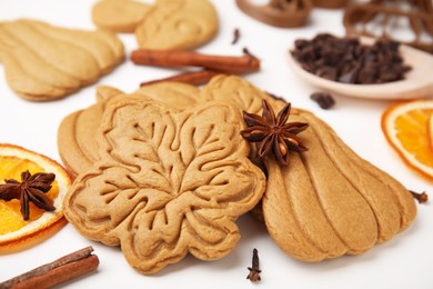 Photo of Tasty cookies and spices on white table, closeup