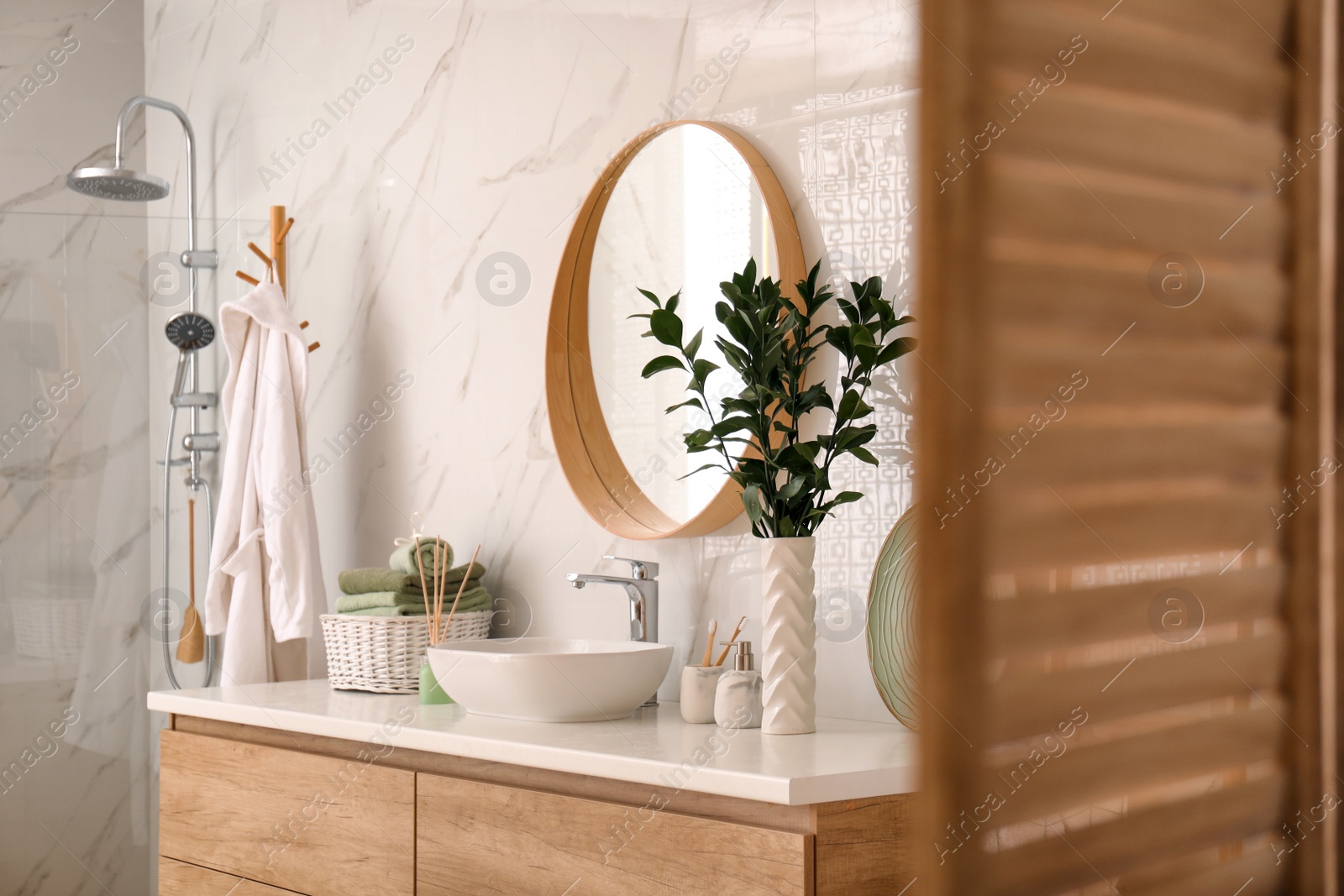 Photo of Modern bathroom interior with stylish mirror and vessel sink