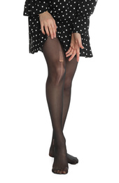 Woman wearing torn tights on white background, closeup