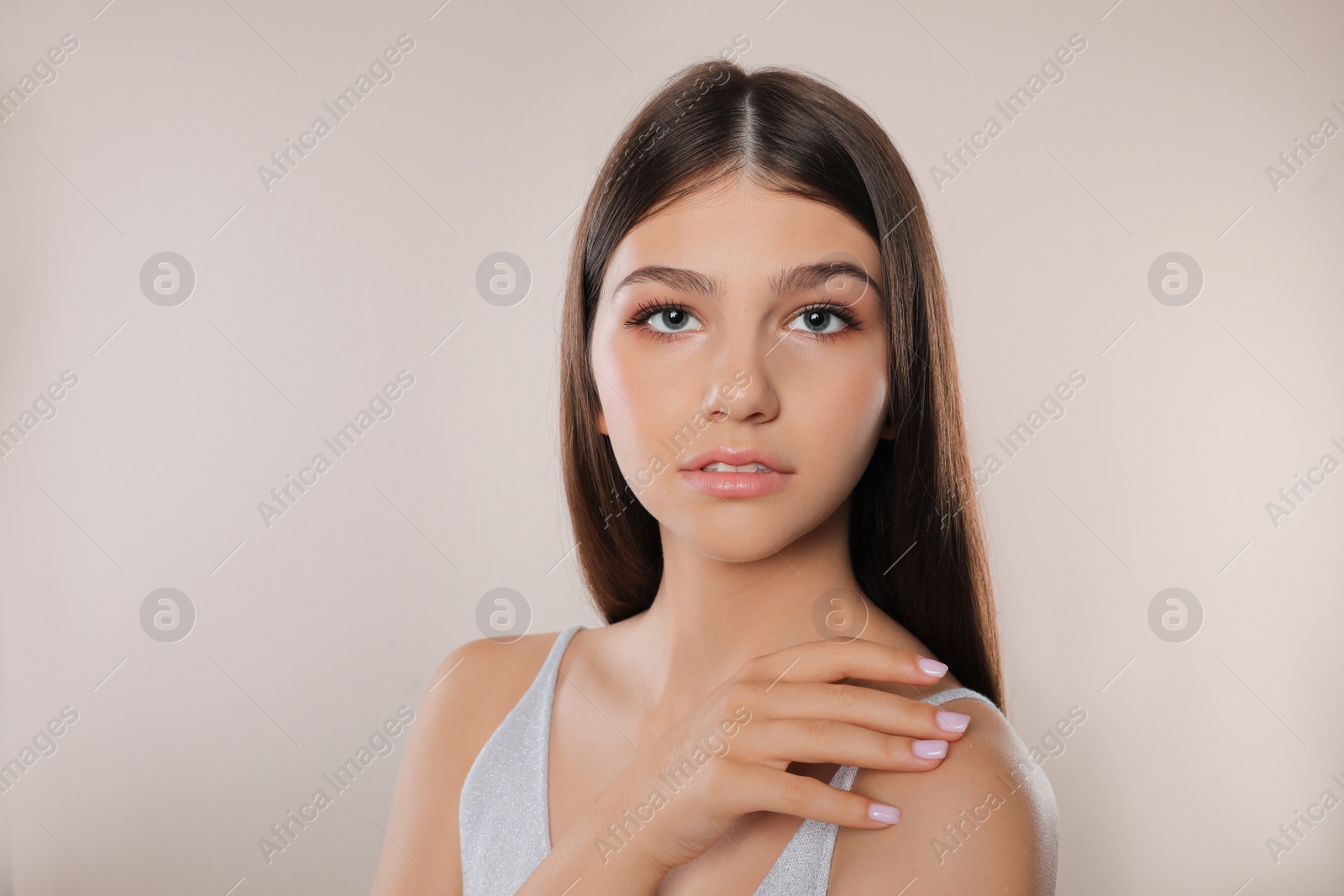 Photo of Portrait of pretty girl on light background. Beautiful face with perfect smooth skin