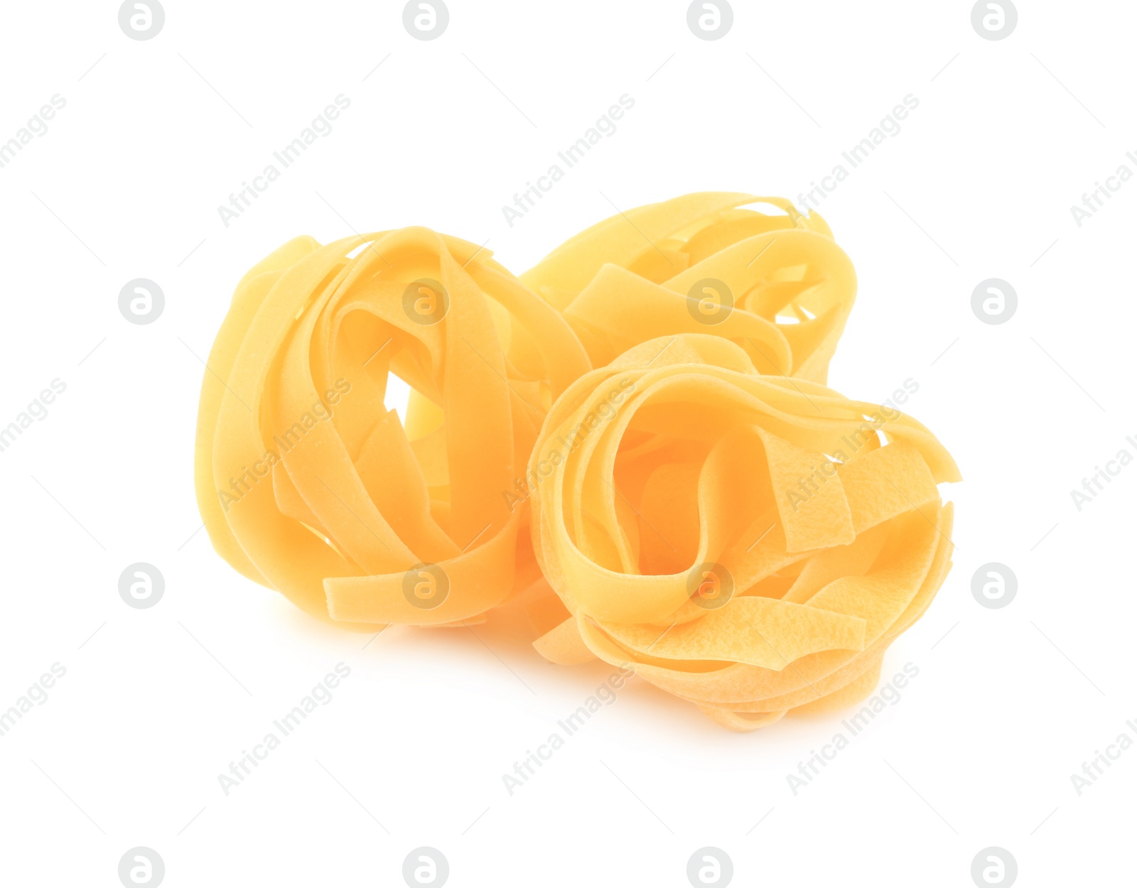 Photo of Raw fettuccine pasta isolated on white. Italian cuisine