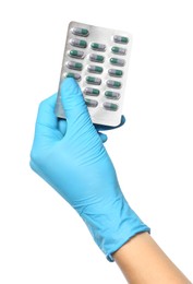 Photo of Scientist in protective gloves holding pills on white background, closeup