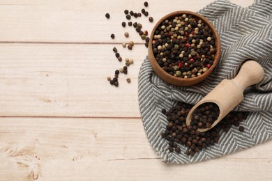 Aromatic spices. Different peppers on wooden table, flat lay. Space for text