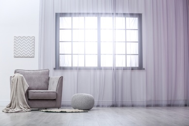 Photo of Stylish comfortable armchair near window