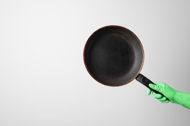 Photo of Woman holding empty frying pan on white background, closeup. Space for text