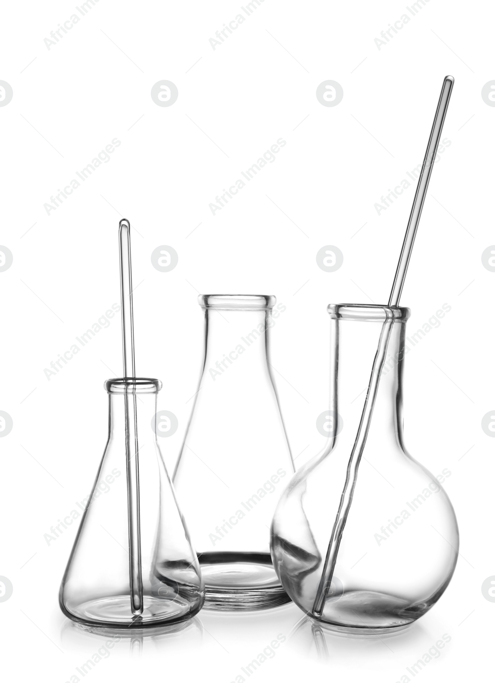 Photo of Clean empty laboratory glassware on white background