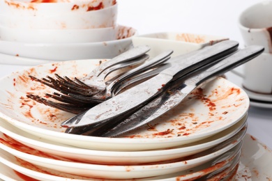 Photo of Pile of dirty dishes and cutlery, closeup