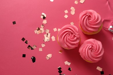 Photo of Delicious cupcakes with bright cream and confetti on pink background, flat lay. Space for text