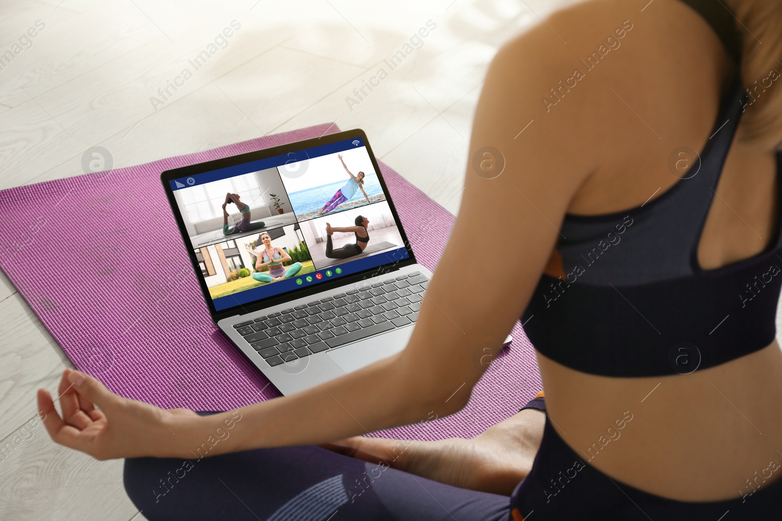 Image of Distance yoga course during coronavirus pandemic. Woman having online video class via laptop at home, closeup 