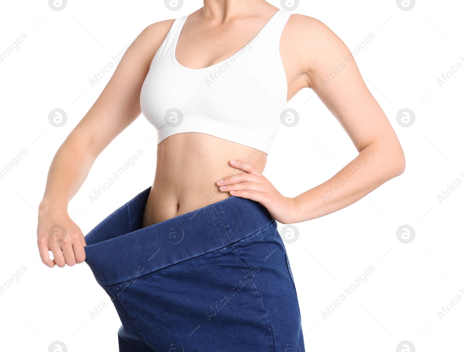 Photo of Young slim woman wearing oversized jeans on white background, closeup