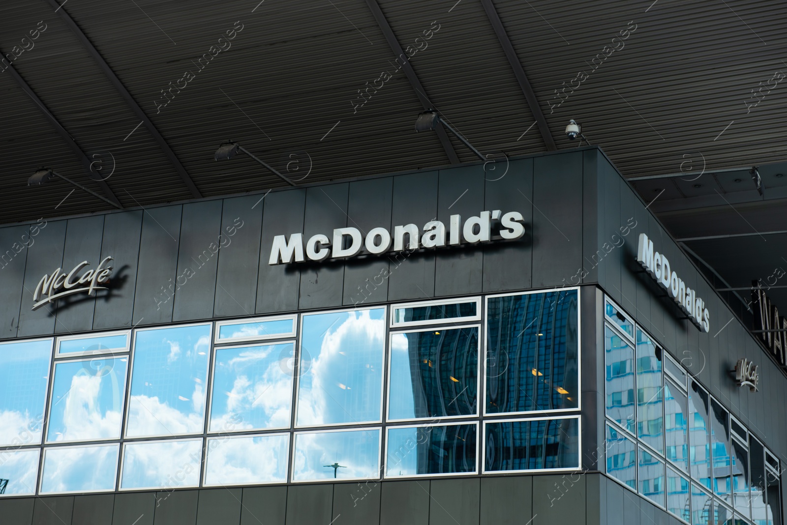 Photo of WARSAW, POLAND - SEPTEMBER 04, 2022: McDonald's Restaurant and McCafe logos on building facade