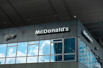 Photo of WARSAW, POLAND - SEPTEMBER 04, 2022: McDonald's Restaurant and McCafe logos on building facade