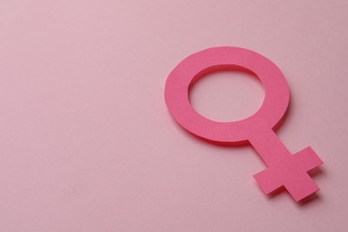 Photo of Female gender sign and space for text on pink background