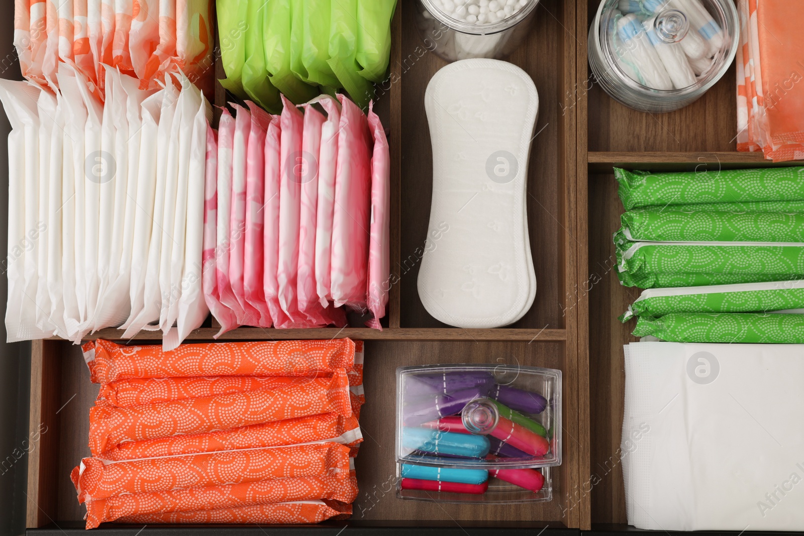 Photo of Storage of different feminine hygiene products in wooden organizers, top view