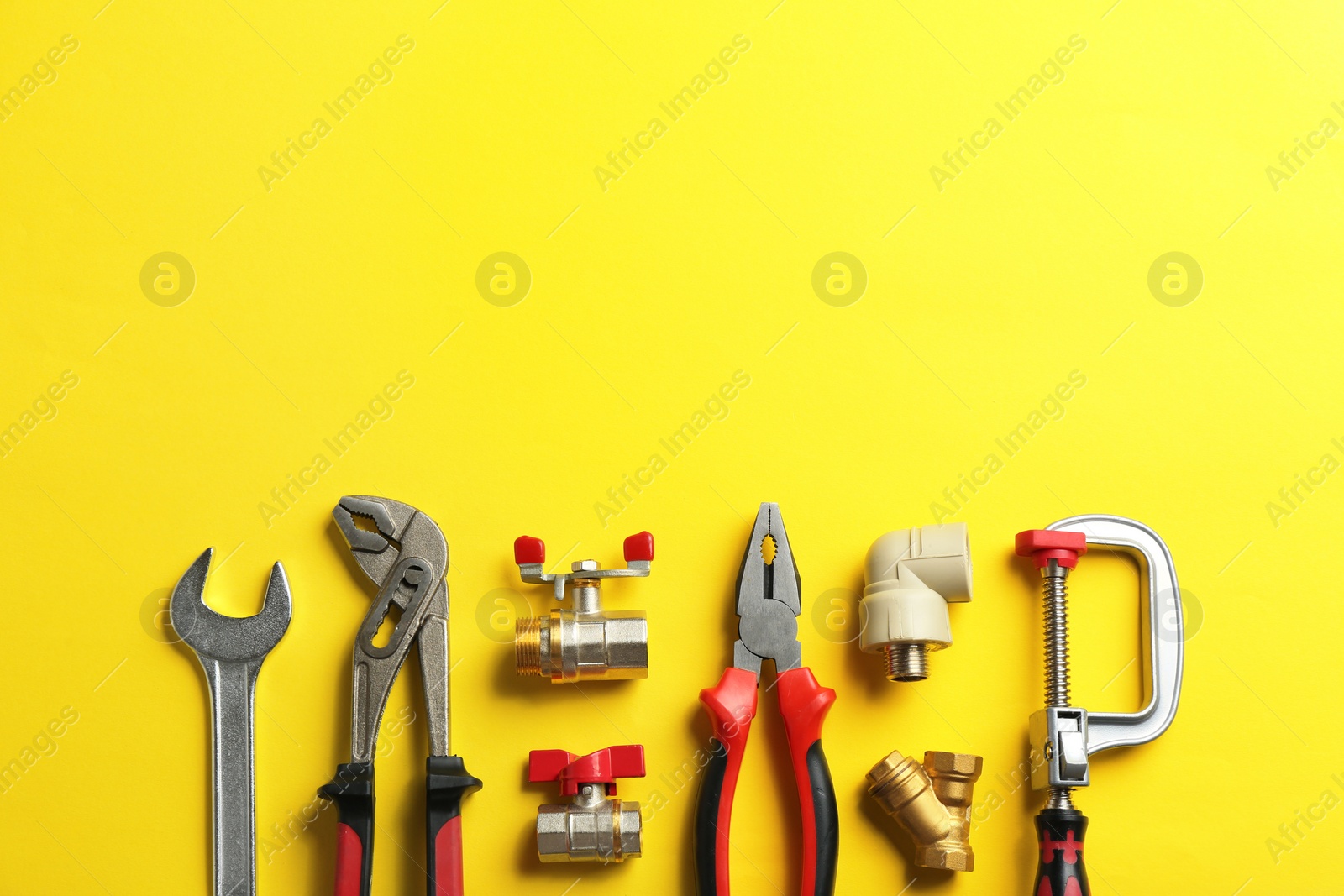 Photo of Flat lay composition with plumber's tools and space for text on color background