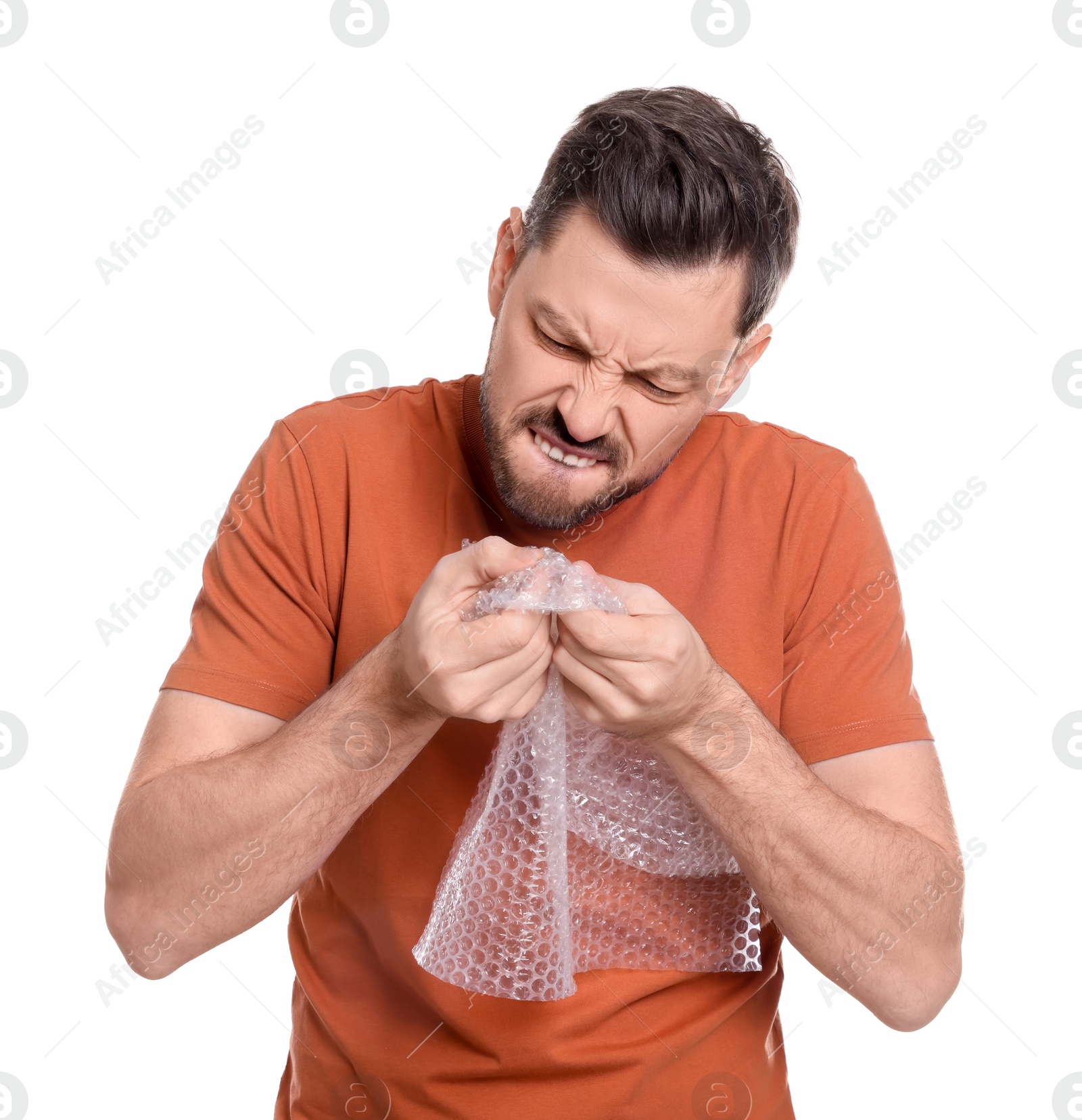 Photo of Man popping bubble wrap on white background. Stress relief