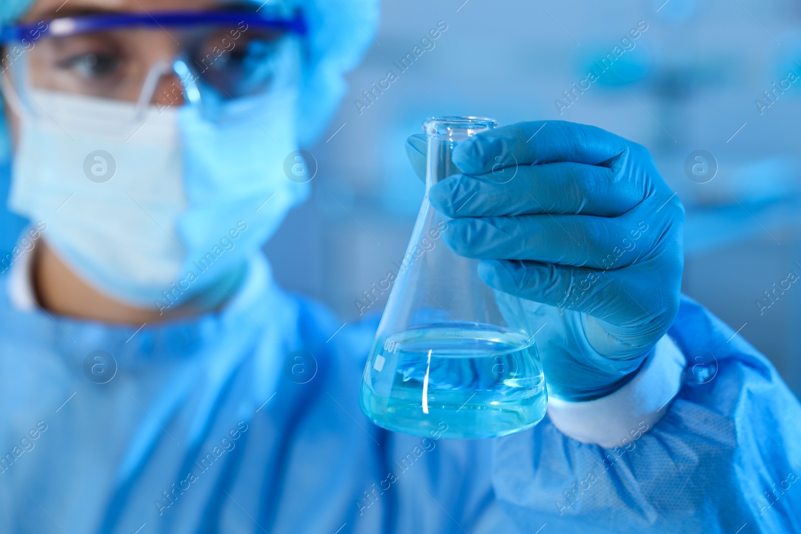 Photo of Scientist working with sample in laboratory, focus on hand. Medical research