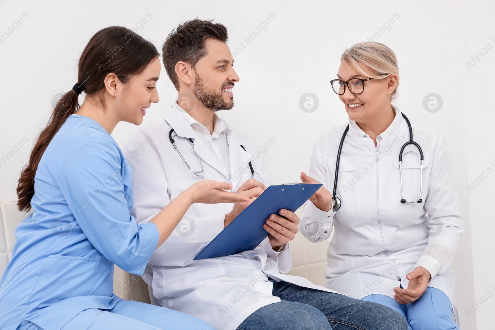Photo of Team of professional doctors working in office
