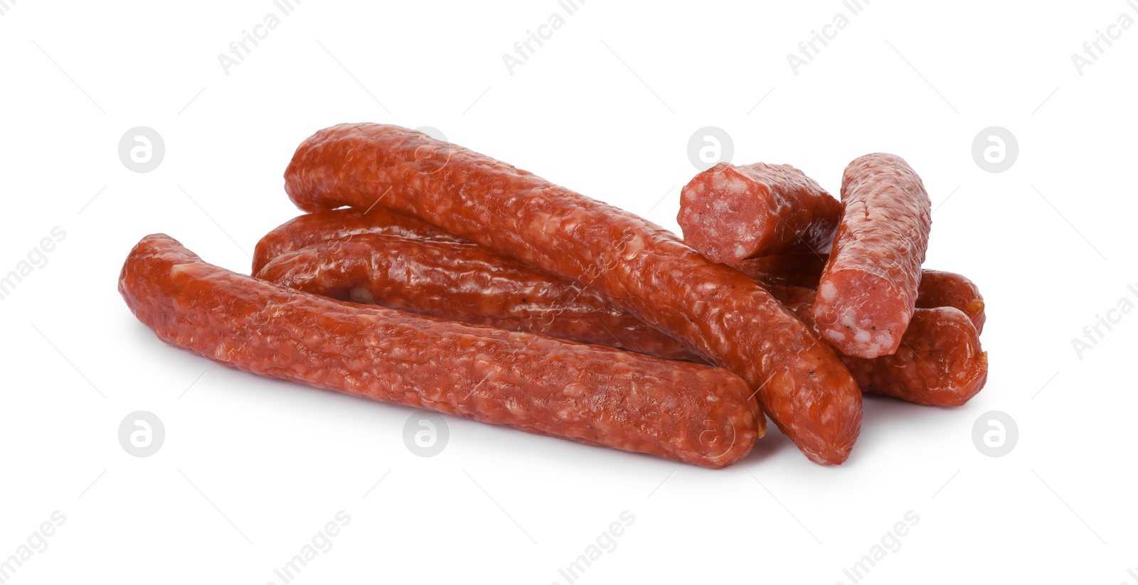 Photo of Many thin dry smoked sausages isolated on white