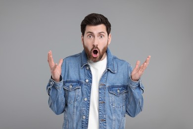 Photo of Portrait of surprised man on grey background