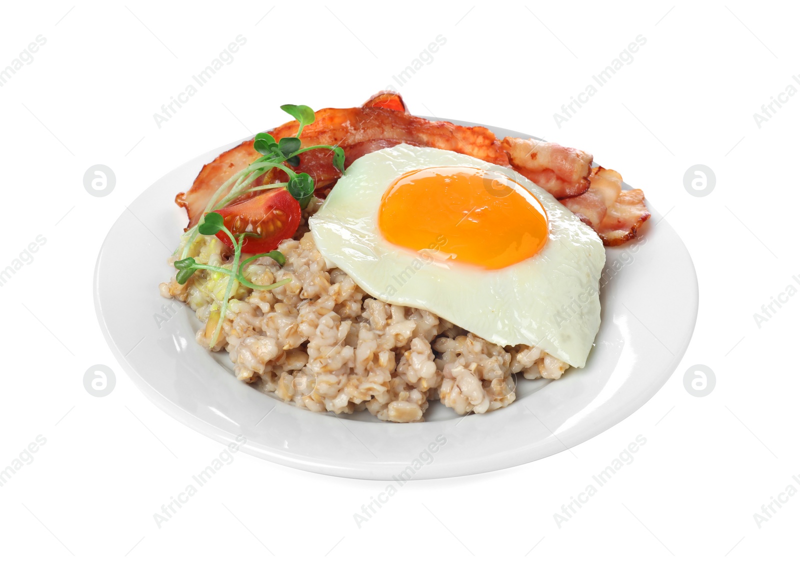 Photo of Tasty boiled oatmeal with fried egg, bacon and tomato isolated on white