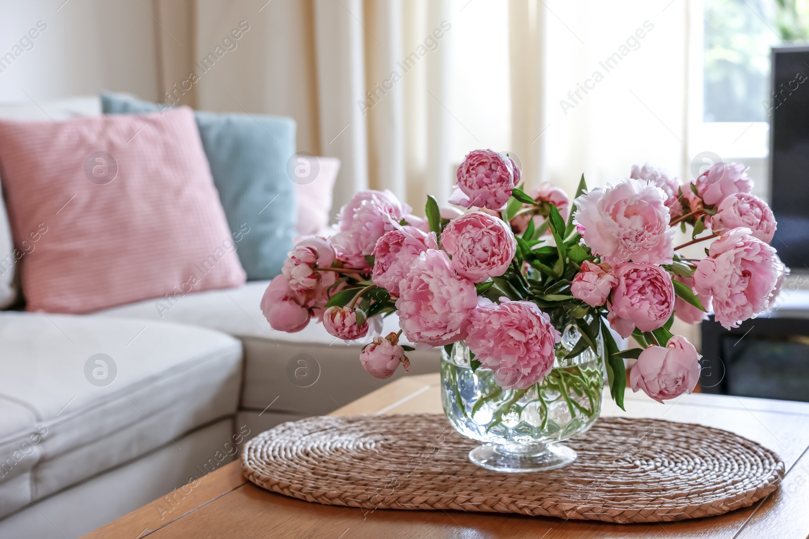 Photo of Beautiful pink peonies in vase on table at home, space for text. Interior design