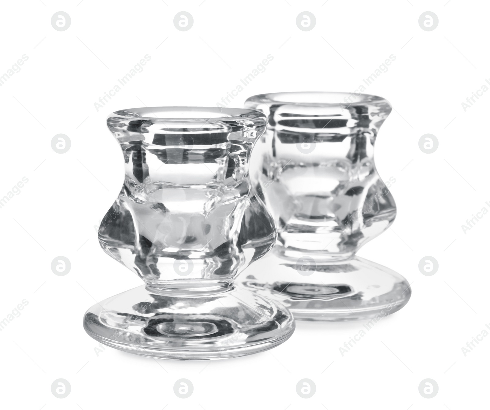 Photo of Small modern glass candlesticks on white background