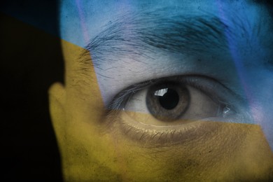 Double exposure of Ukrainian national flag and man, closeup view