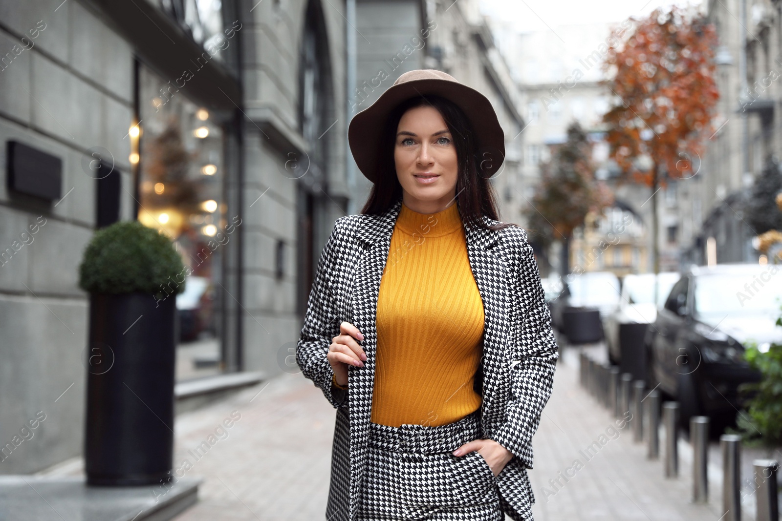 Photo of Portrait of beautiful woman in stylish suit on city street