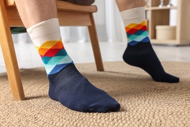 Photo of Man in stylish colorful socks indoors, closeup