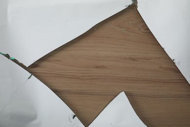 Shards of broken mirror on wooden backing board, top view