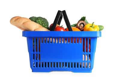 Photo of Shopping basket with grocery products on white background