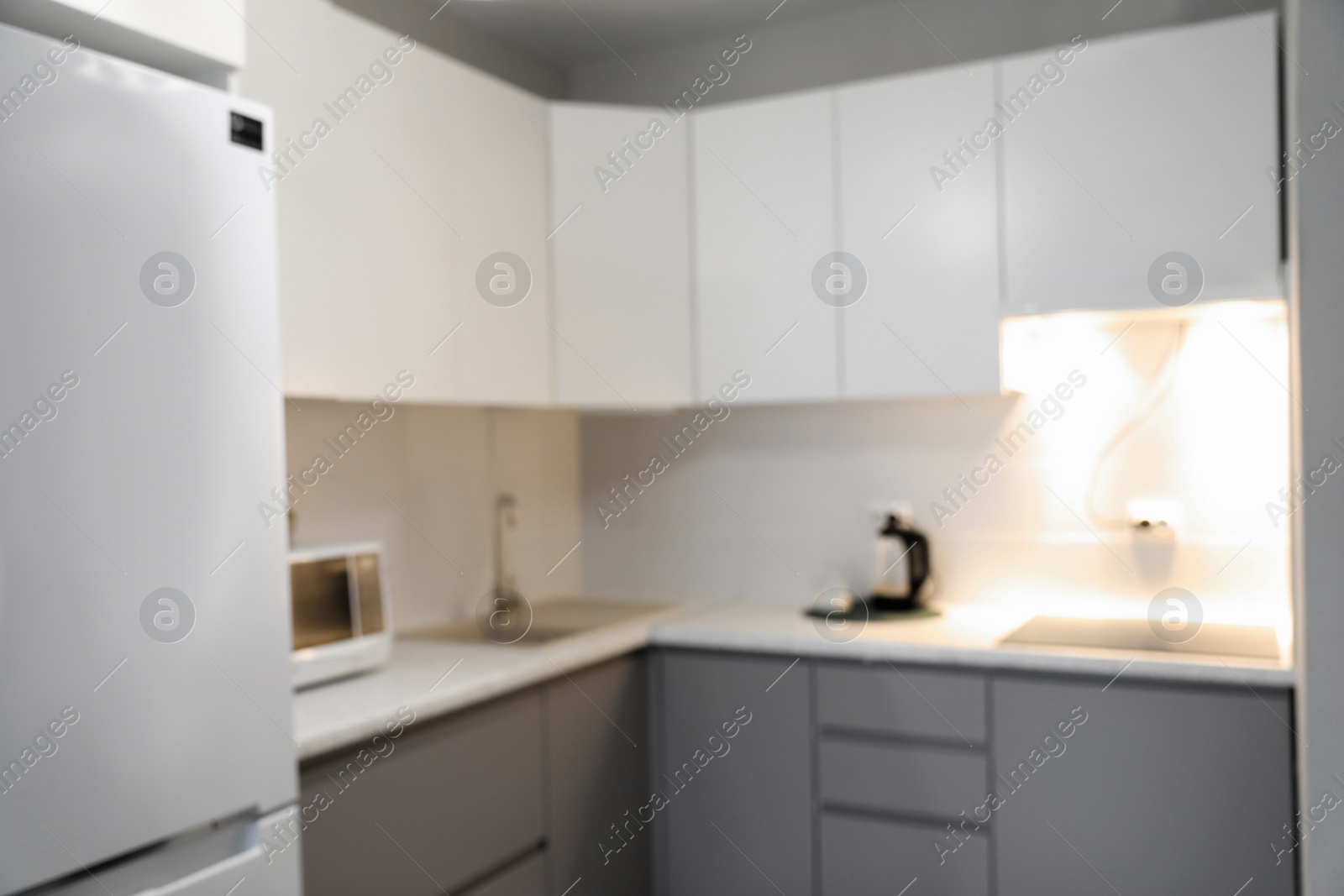 Photo of Blurred view of stylish modern kitchen interior