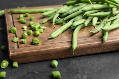 Fresh green beans on black table, closeup