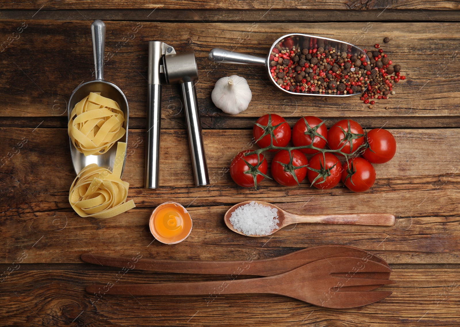 Photo of Cooking utensils and ingredients on wooden table, flat lay