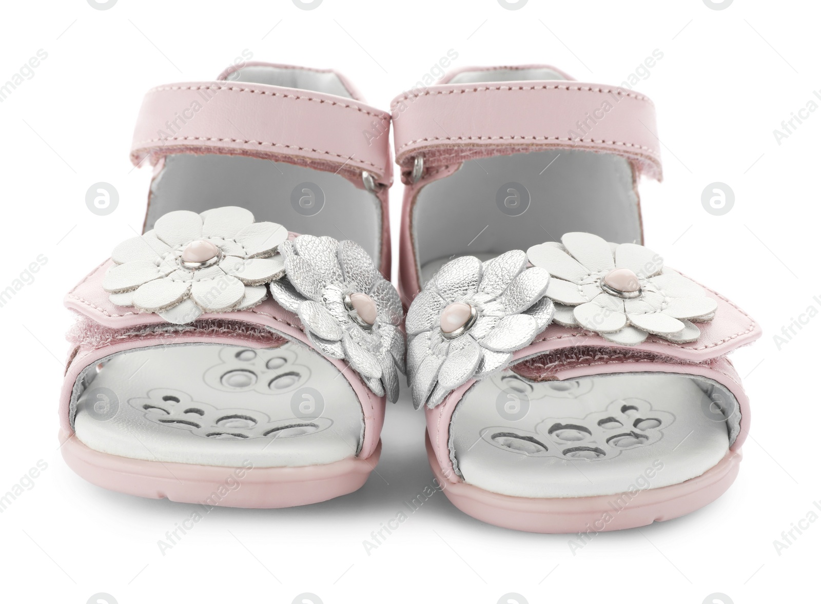 Photo of Pair of pink baby sandals decorated with flowers on white background