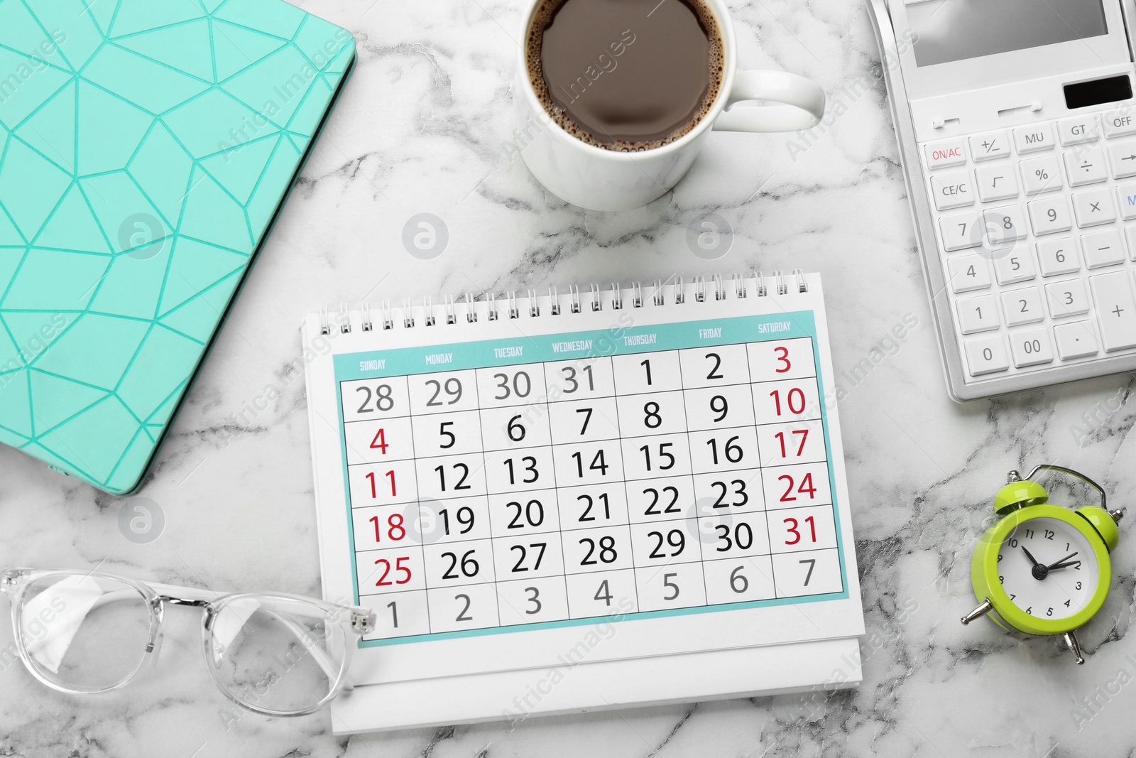 Photo of Flat lay composition with calendar and cup of coffee on white marble table