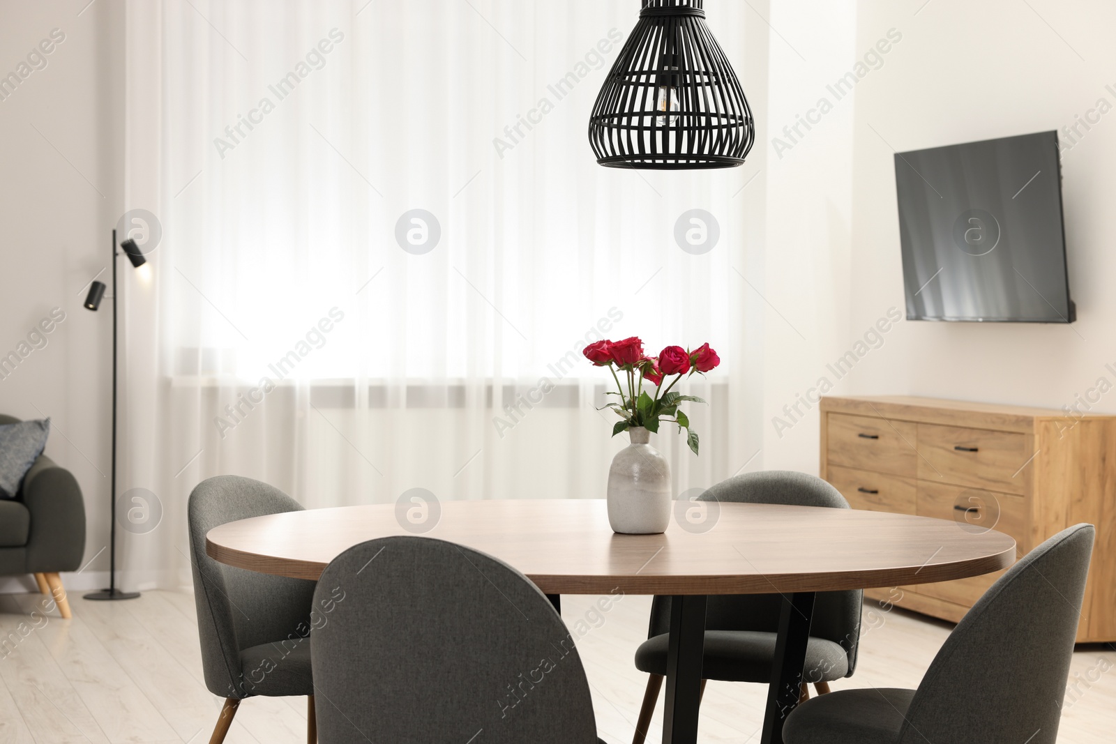 Photo of Stylish dining room interior with comfortable furniture