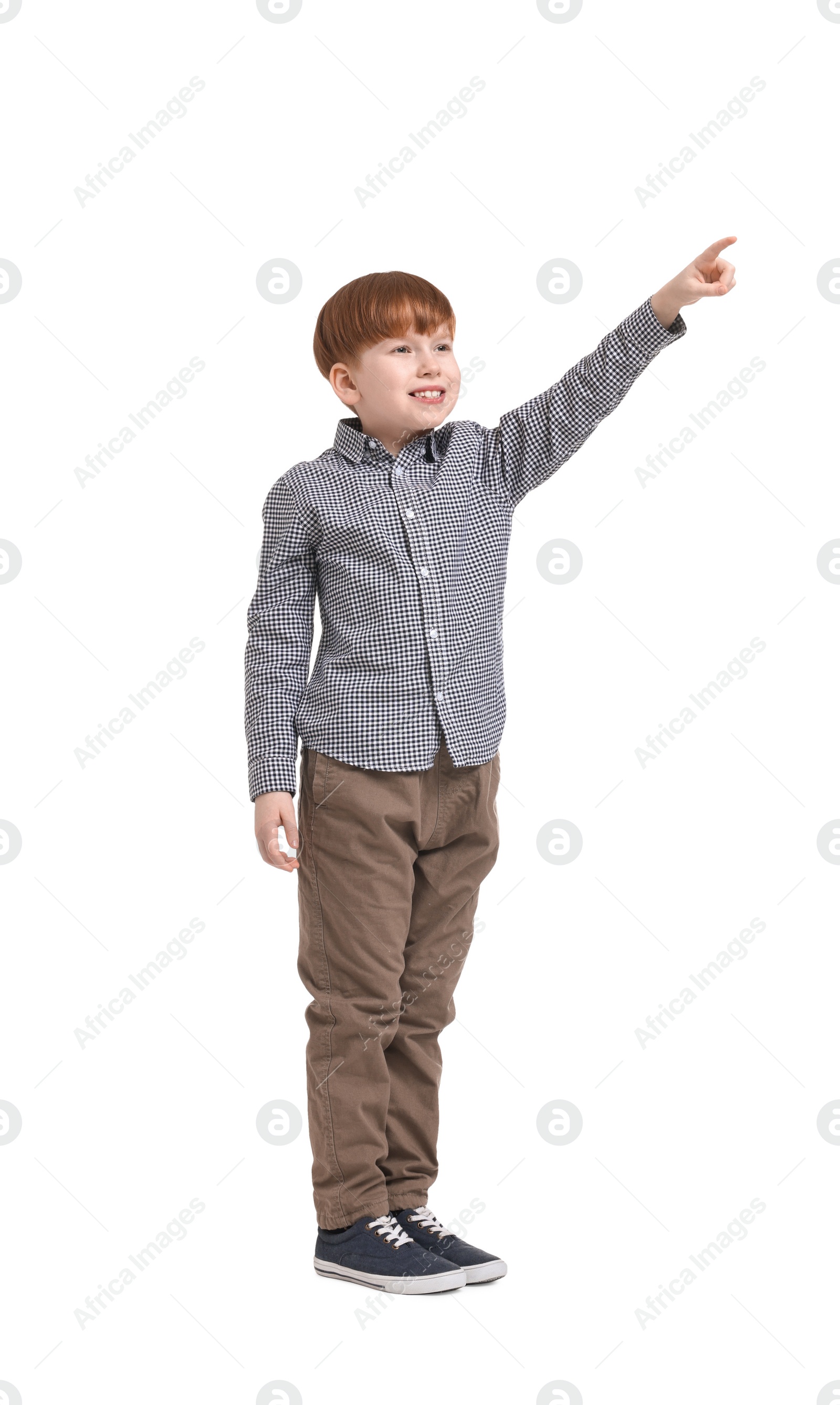 Photo of Little boy pointing at something on white background