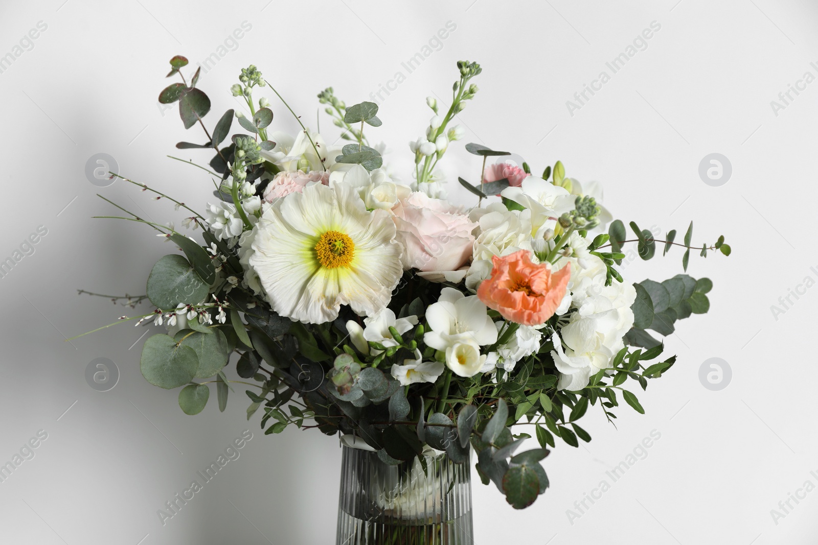 Photo of Bouquet of beautiful flowers in vase on white background, closeup