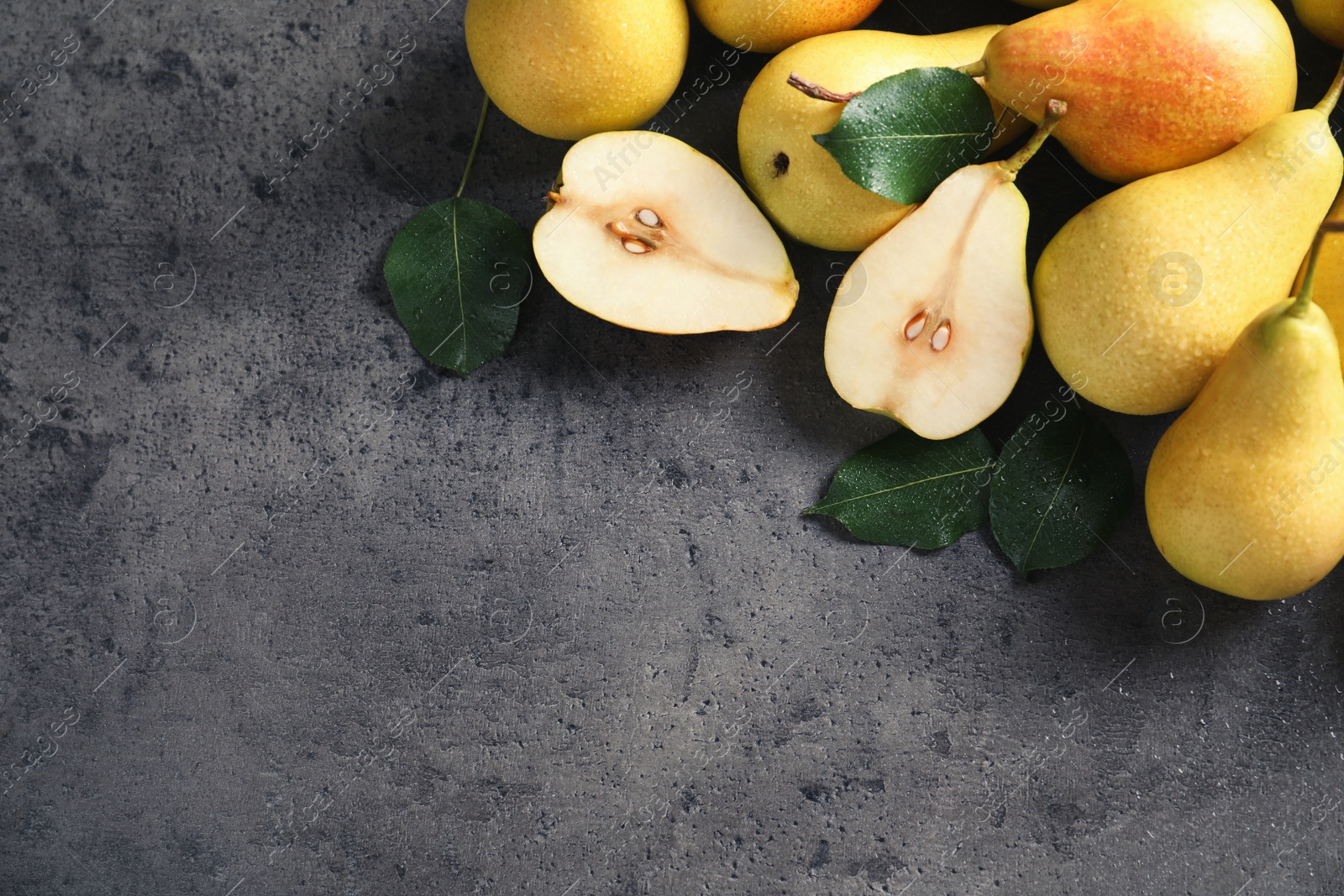 Photo of Ripe pears on grey background, top view. Space for text