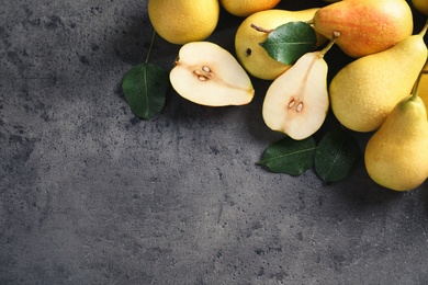 Ripe pears on grey background, top view. Space for text