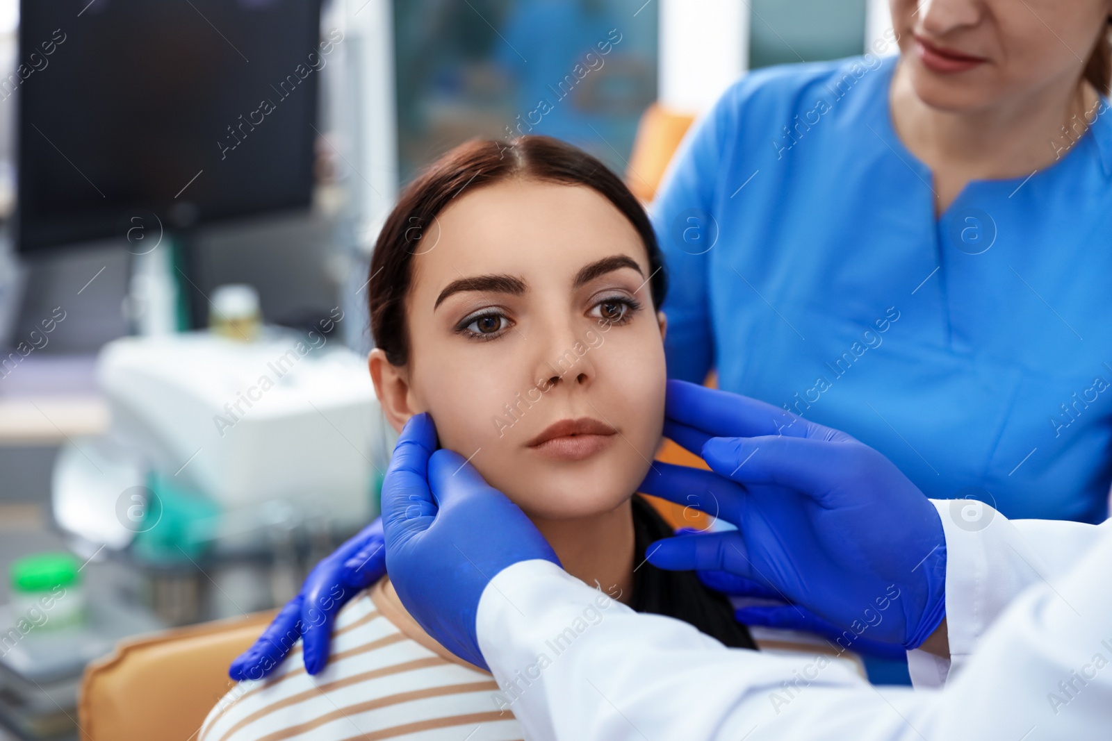 Photo of Professional doctors examining patient before surgery in clinic