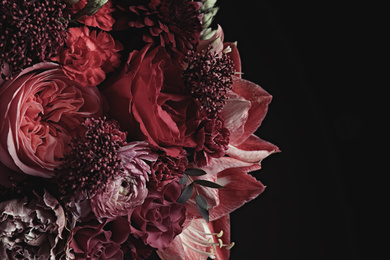 Photo of Beautiful bouquet of different flowers on black background. Floral card design with dark vintage effect