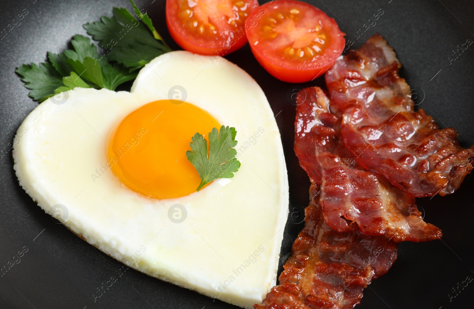 Photo of Closeup view of delicious breakfast with heart shaped fried egg