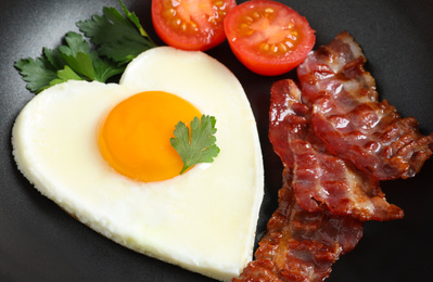 Closeup view of delicious breakfast with heart shaped fried egg